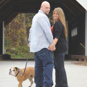 Couple with boxer dog on a covered bridge. Pet friendly Inns - the Phineas Swann Inn