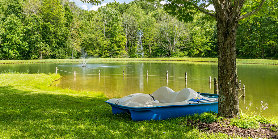 Boat by the pond at family friendly Bear Creek Bed and Breakfast