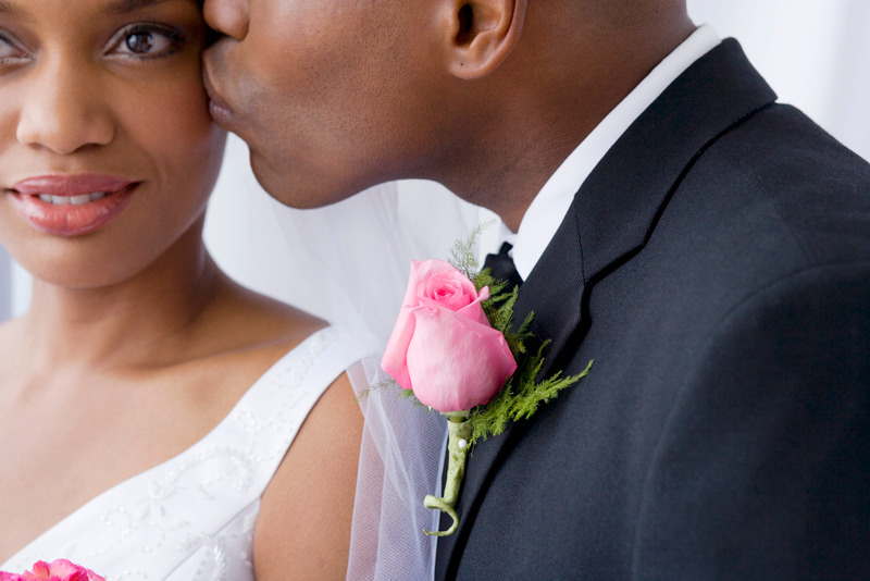 Groom kissing bride, close up, purchase gift certificates online