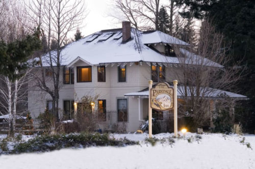 Mount Hood Bed and Breakfast, the Parkdale Inn glowing on a snowy day.