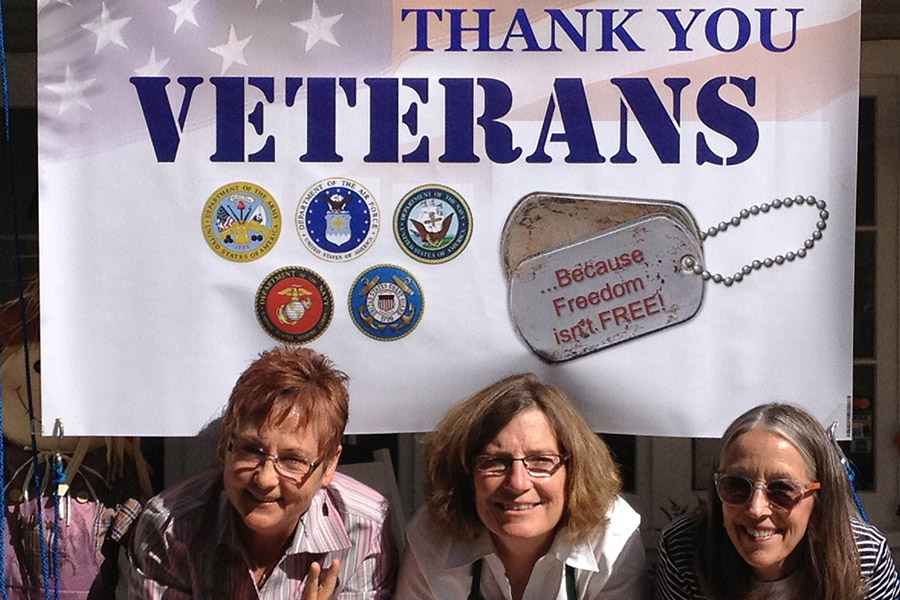 Innkeepers thanking Vets with flag at a B&B